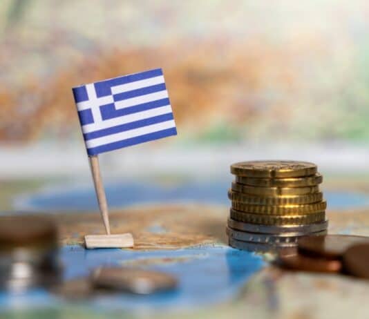 greek flag and coins on map, source: Shutterstock