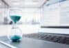 hourglass on laptop, time is money visualization, source: Shutterstock