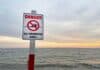 "No swimming" beach sign, source: Shutterstock