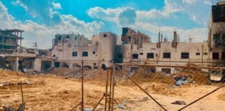Gaza building and fence, source: Gaza - Survival Journey / Shutterstock.com