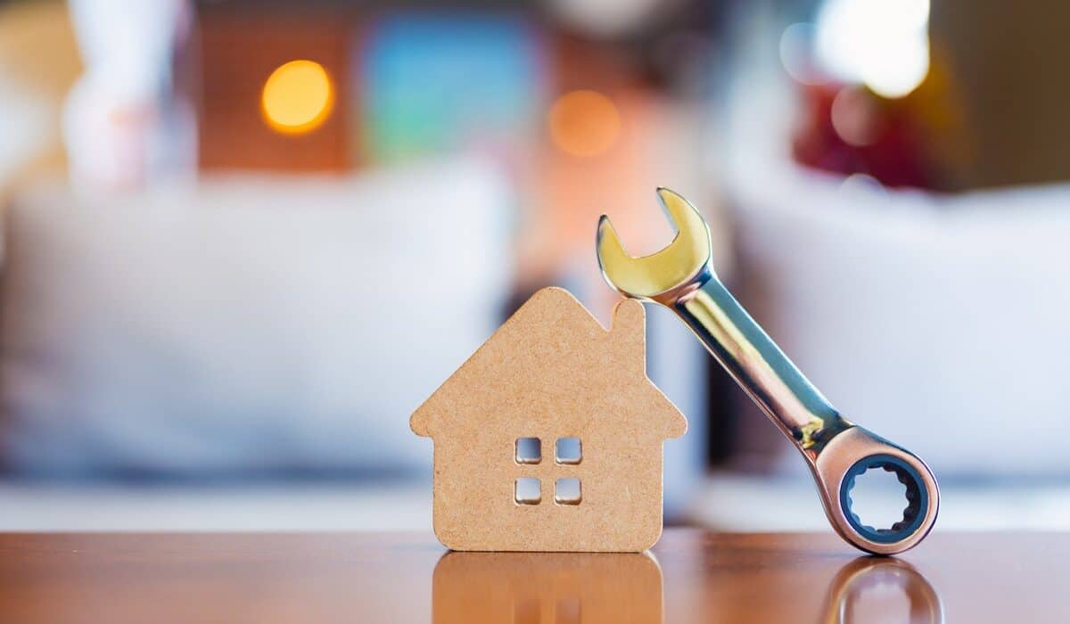 House,Model,With,Metal,Wrench,Symbolizes,Home,Maintenance,,Repair,,And